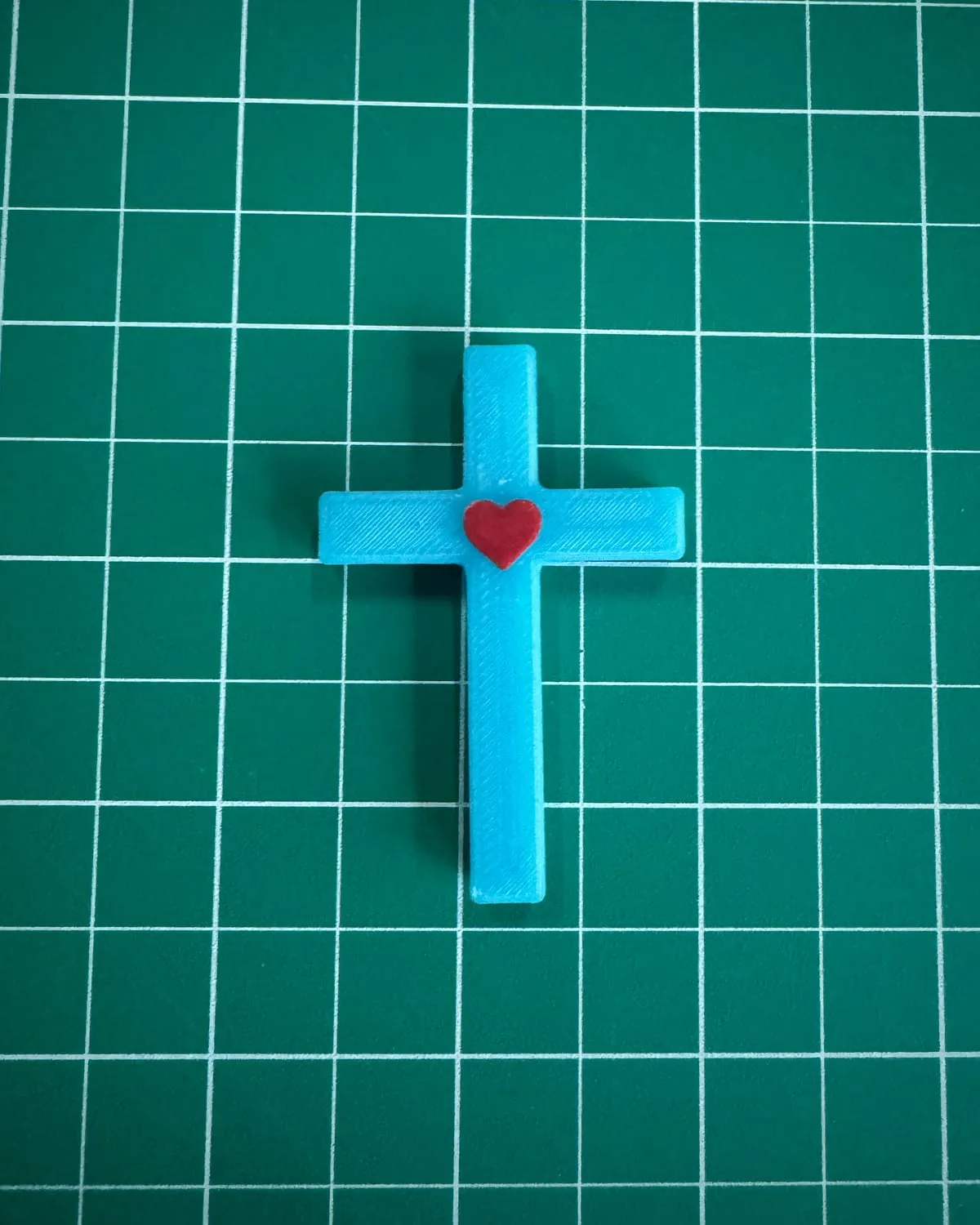 A blue Heart Cross with a red heart