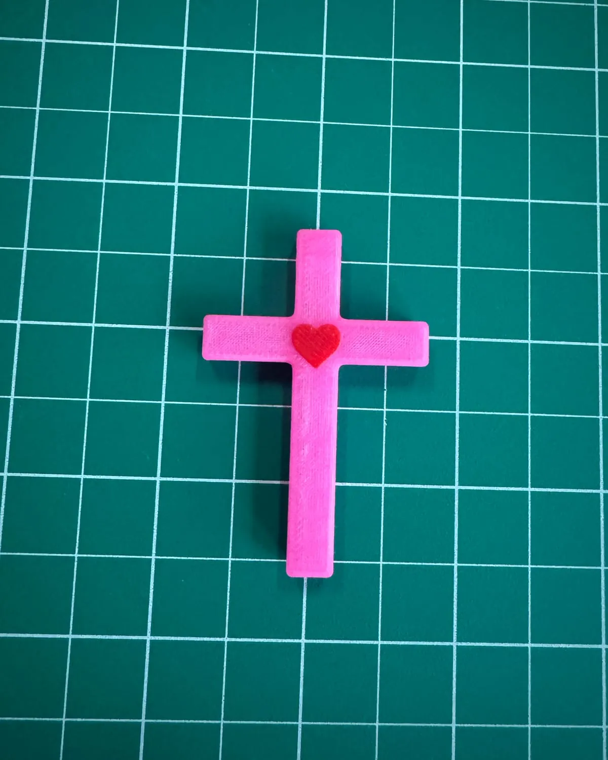A pink Heart Cross with a red heart